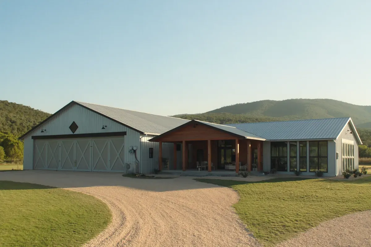 A Texas Hill Country barndominium with a metal shop wing and a finished living wing under one roof